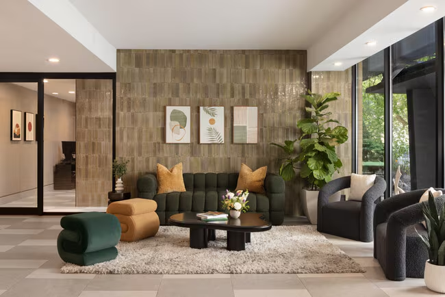 Residential lobby lounge — seating, planting and natural light in a CMAI-managed building